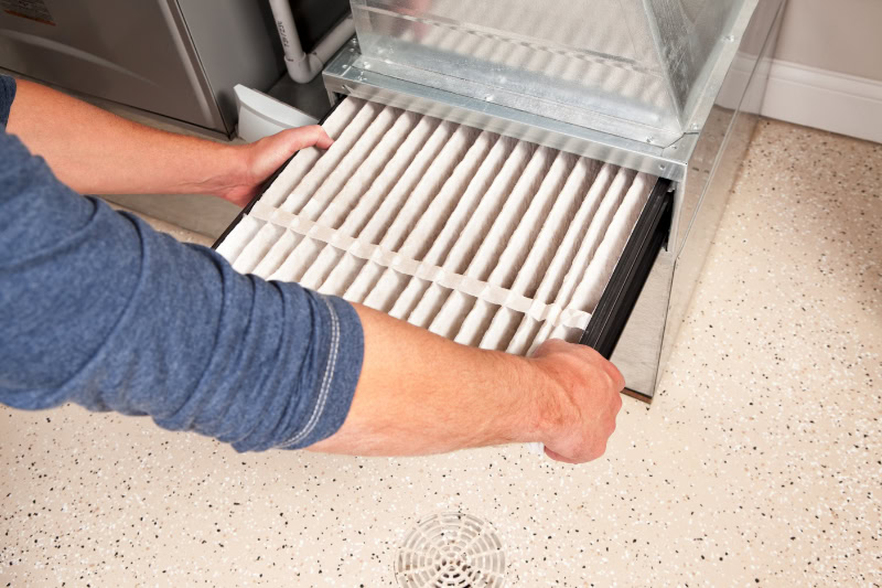 Hands Changing Furnace Air Filter.