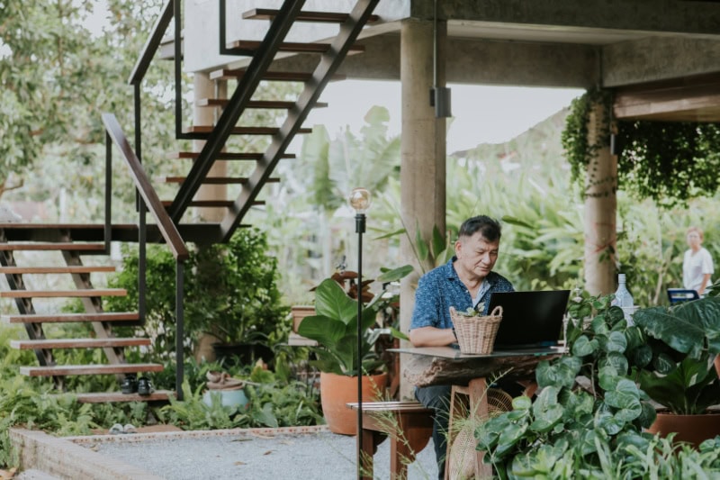 Man working at home while using computer with family.