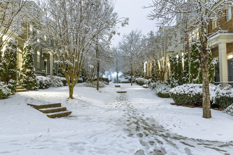 Typical townhouses on United State suburbs with a courtyard in the middle and no numbers showing on the houses on a typical winter wonderland setting